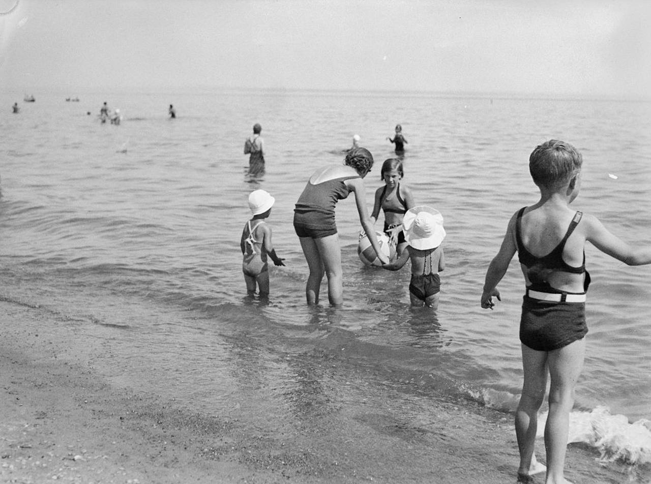 A family plays in the water on a Toronto beach in July 1936