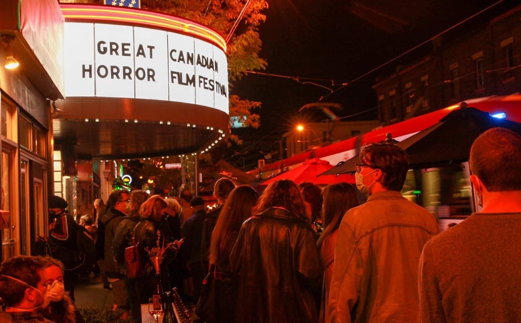 Movie goers pass by the Great Canadian Horror Film Festival during the pandemic.