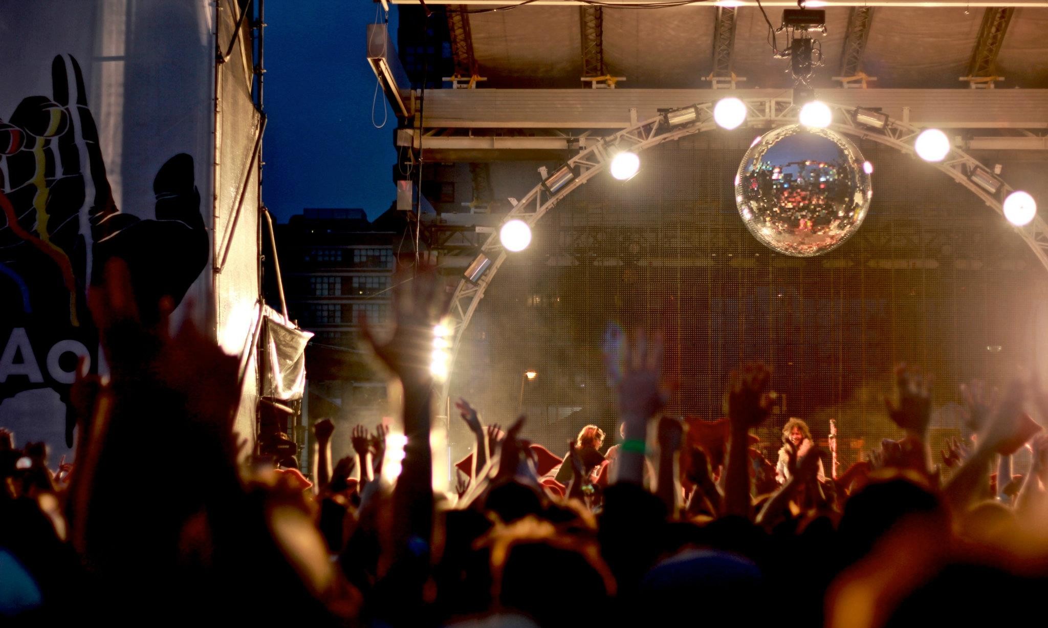 A photo of an evening concert at Yonge and Dundas, taken from the crowd