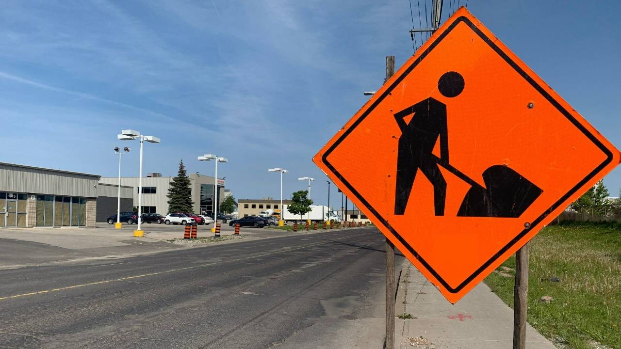 An image of an orange road construction sign next to Barton St. in Hamilton
