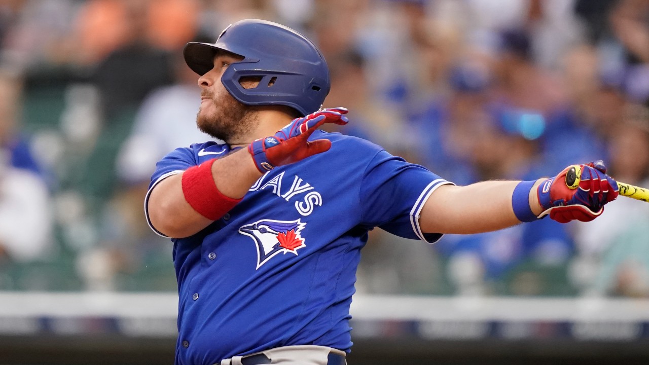 Toronto Blue Jays catcher Alejandro Kirk watches the ball after swinging the bat