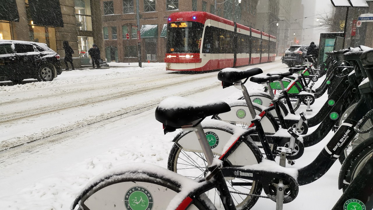 A photo of Bike Share Toronto bikes at a station in snowy weather