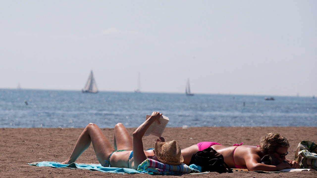 An image of people sunbathing on a sunny day at Cherry Beach in Toronto
