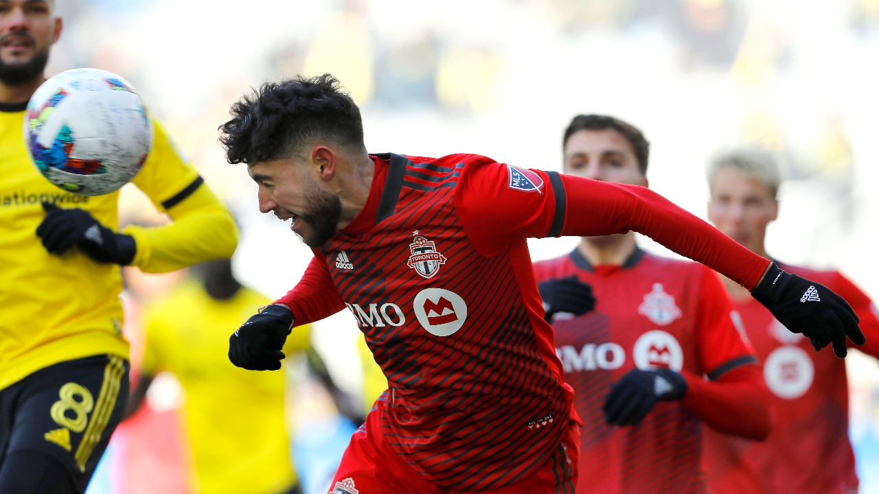 Toronto FC midfielder Jonathan Osorio heads the ball during an MLS soccer match