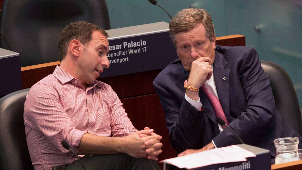 An image of Toronto politicians Josh Matlow and John Tory speaking in city council chambers in 2018