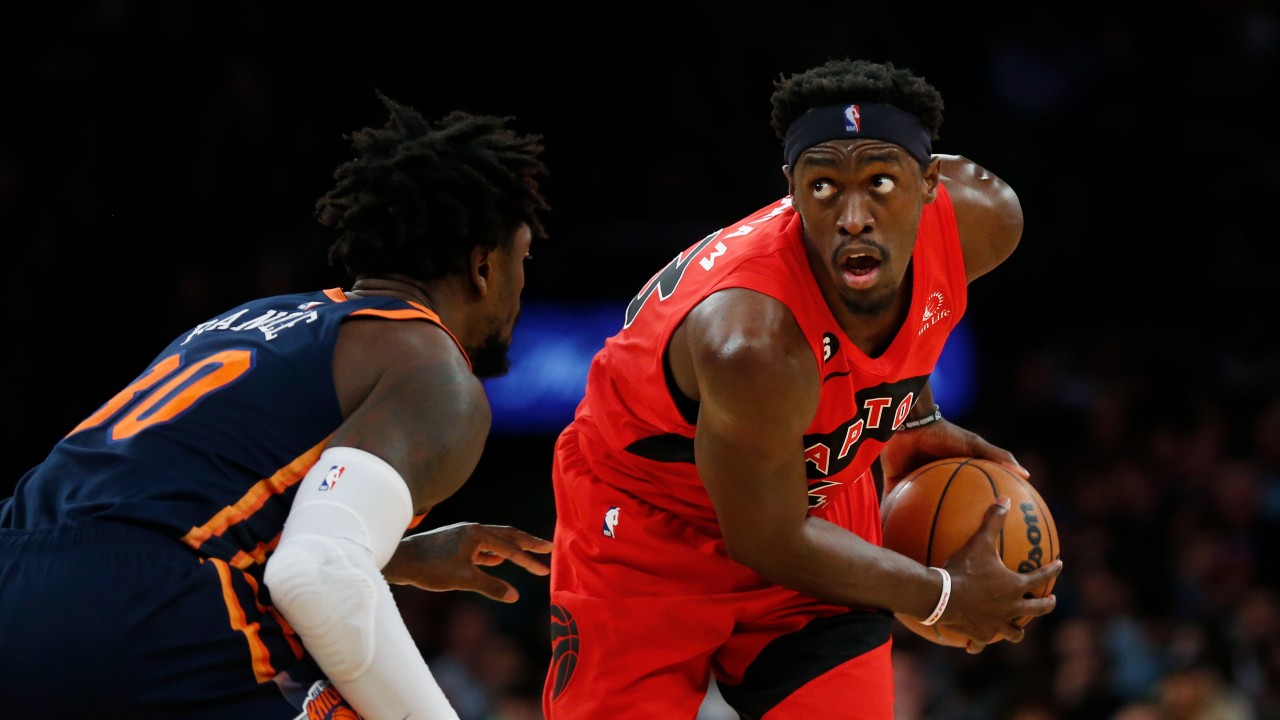 Toronto Raptors forward Pascal Siakam surveys the court while New York Knicks forward Julius Randle defends