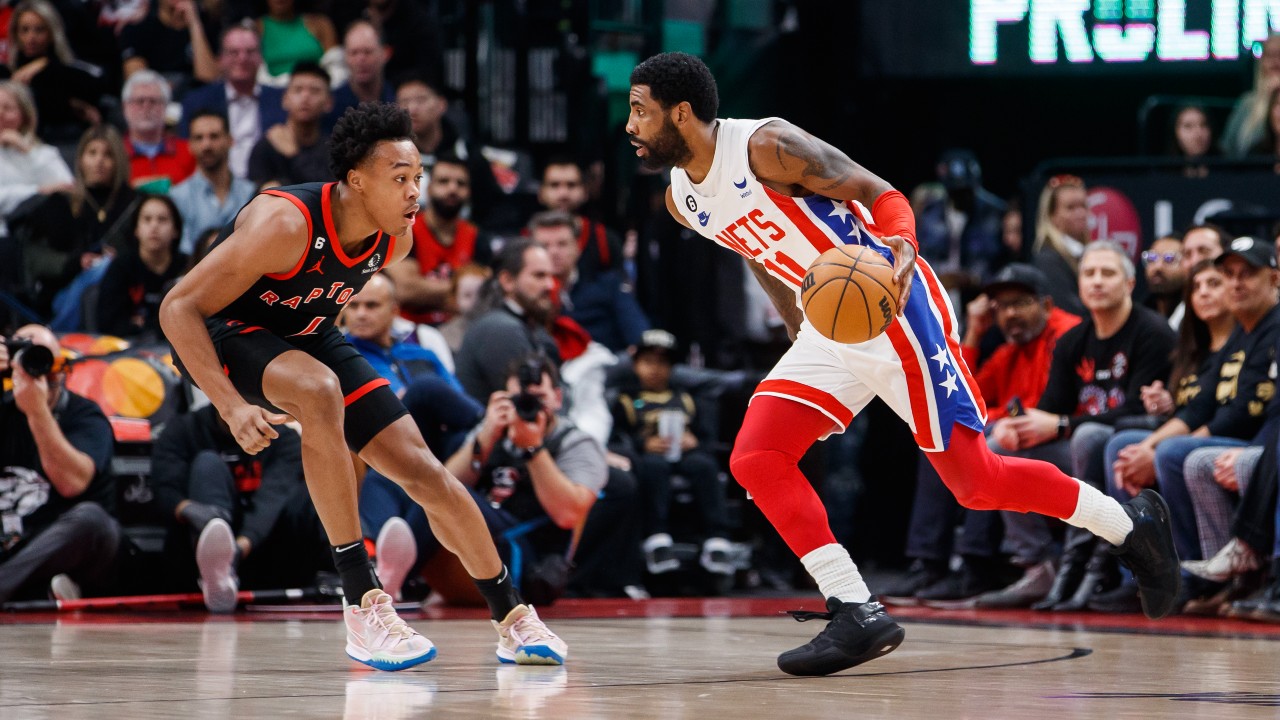 Toronto Raptors forward Scottie Barnes defends against Brooklyn Nets guard Kyrie Irving