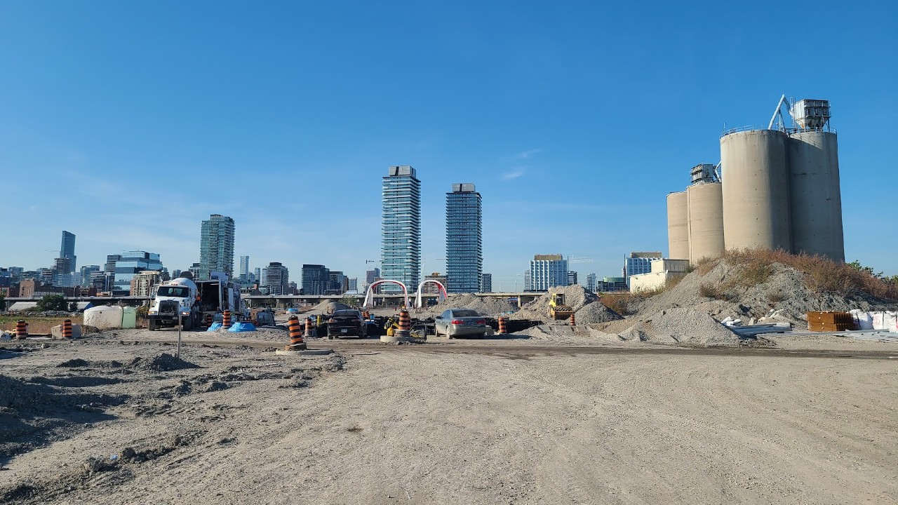 A view of the Lake Ontario Portland Cement Company Silos and new Cherry St.
    bridges looking north from the Villiers Island construction site in 2022
