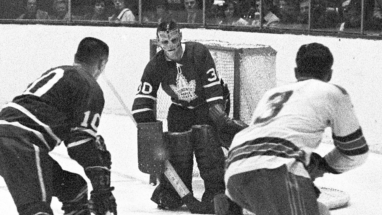 Terry Sawchuk eyes the puck during an NHL game