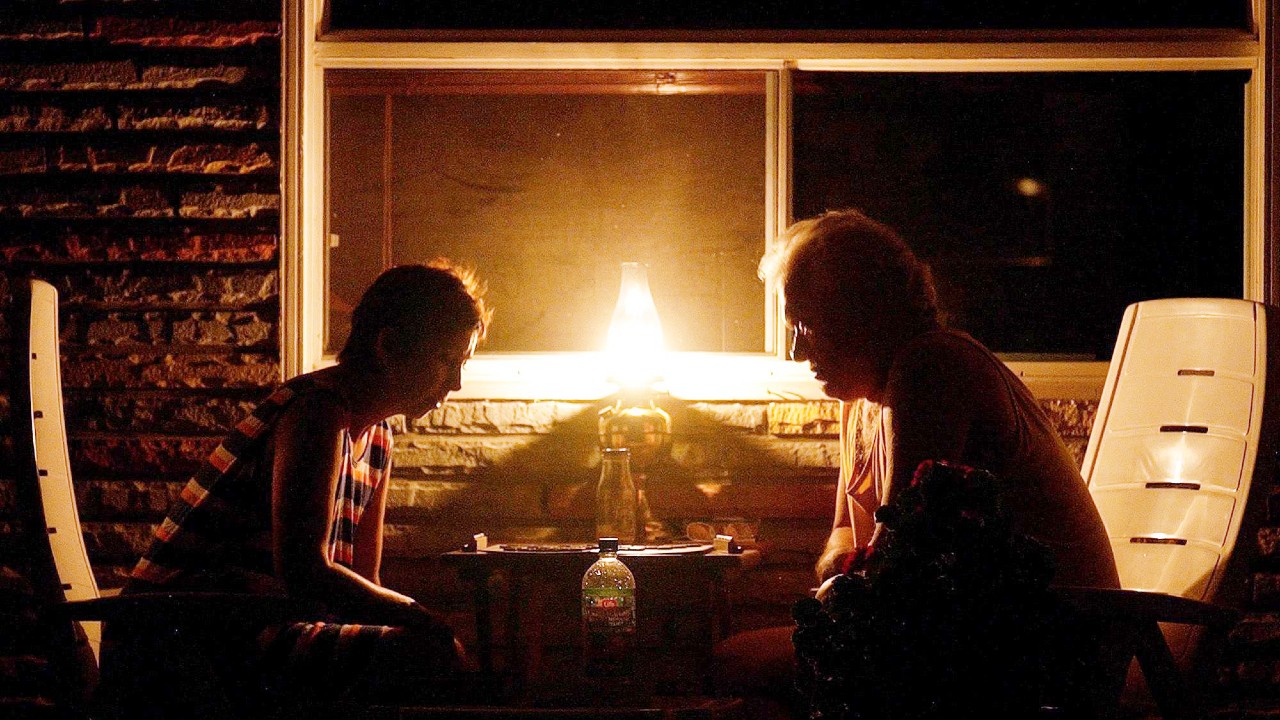 Two people play Scrabble by lantern light during the Northeast blackout of 2003,
    Ontario