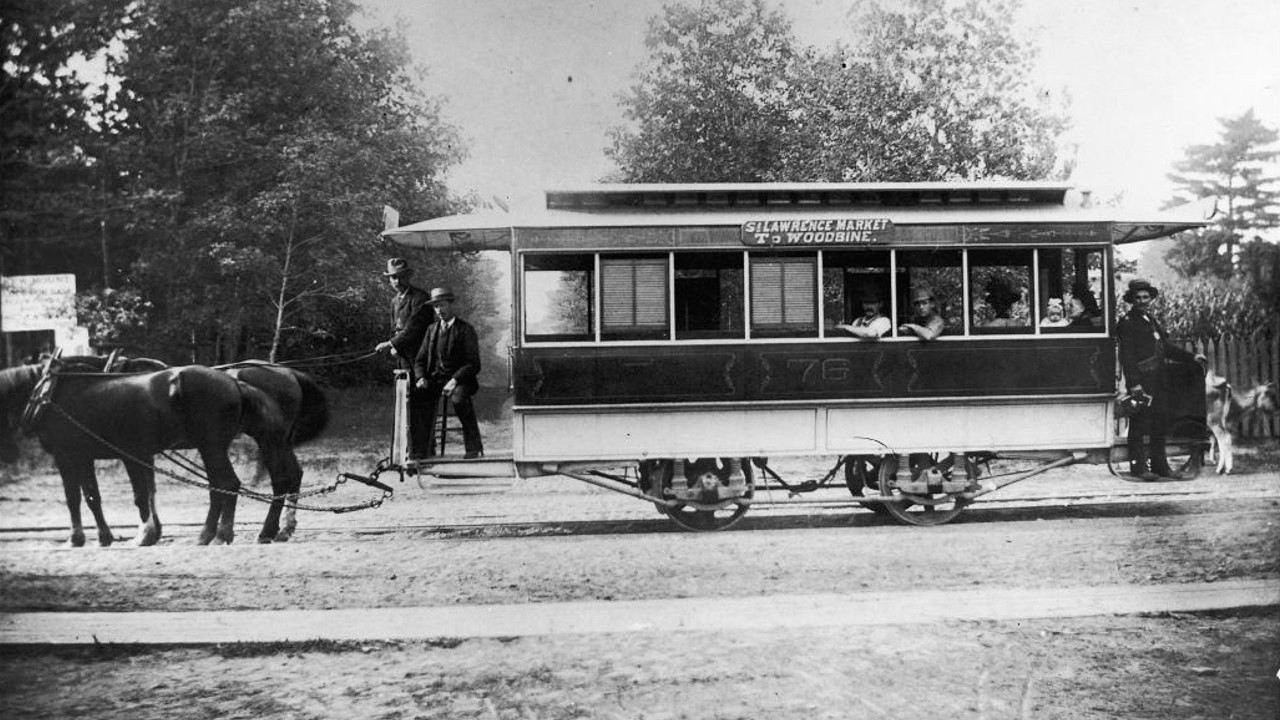 An archival image of a horse-drawn Toronto streetcar, taken in 1892