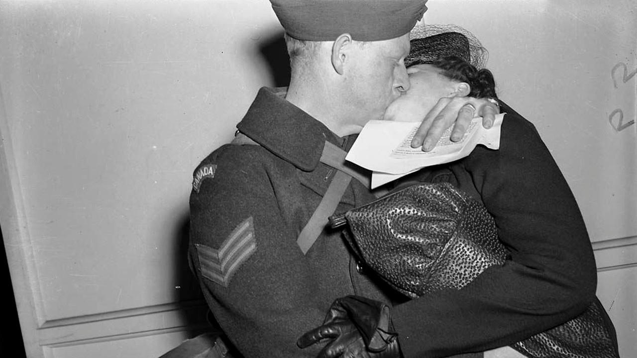 A soldier shares a kiss with a woman in Toronto during the 1940s