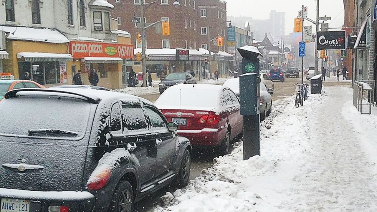 An image of cars parking near a Green P parking machine on Church St. near Wellesley St. in Toronto in 2014