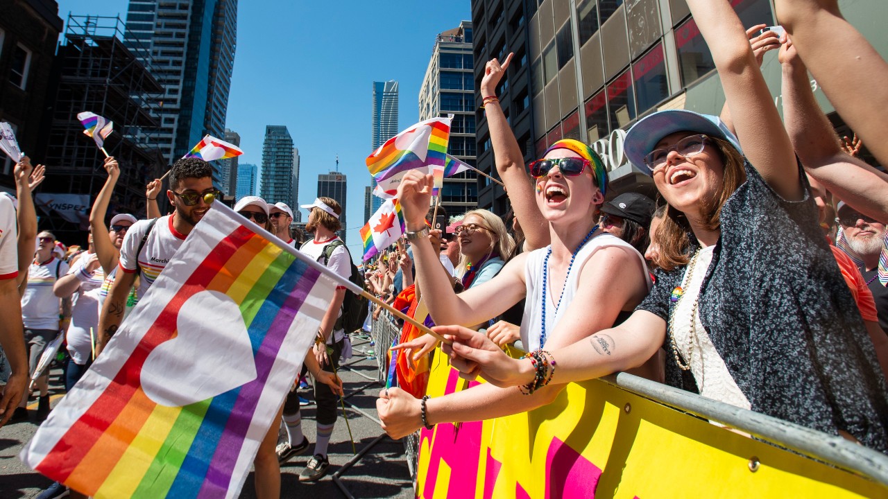 Revelers cheer along the route of the 2019 Pride Parade in Toronto