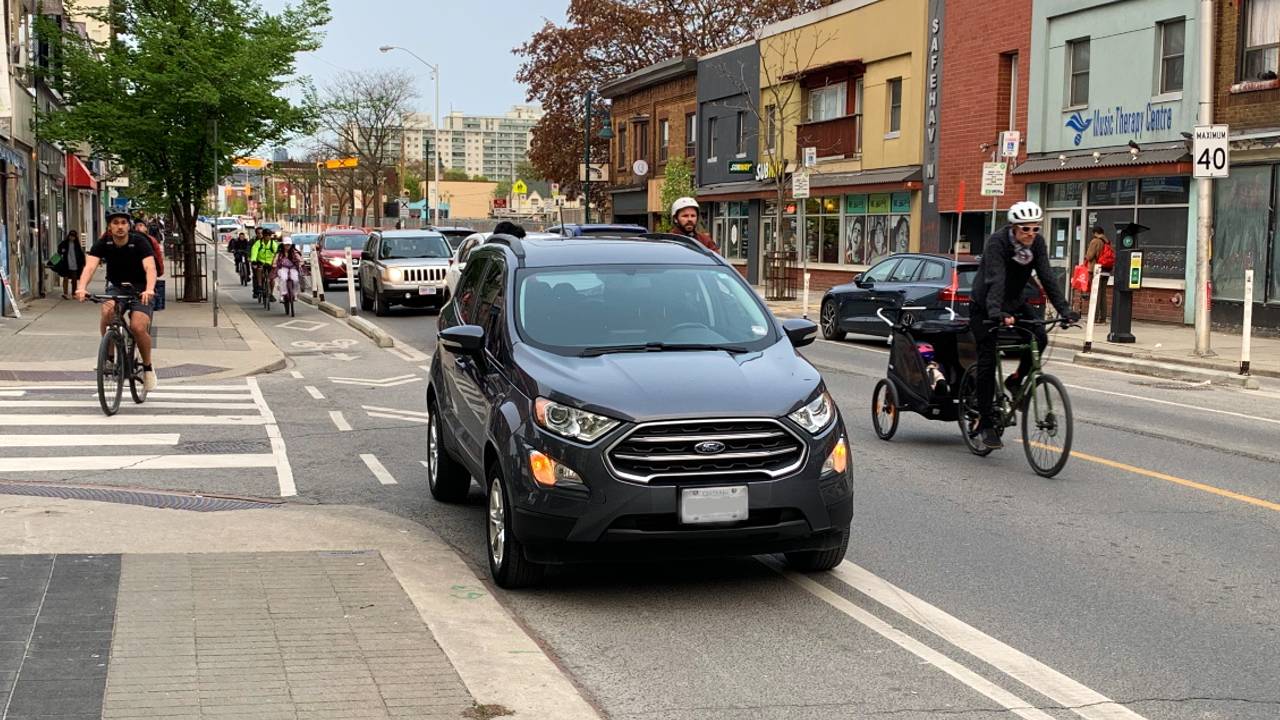 An image of a vehicle parked in a Bloor St. W. bike lane at Brock Ave.